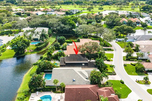 an aerial view of residential houses with outdoor space and swimming pool