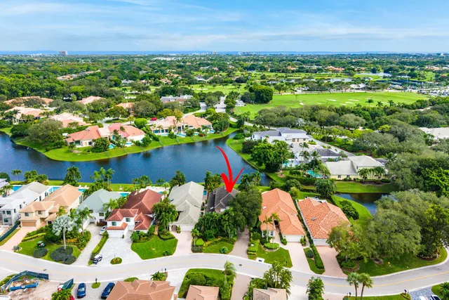 an aerial view of residential houses with outdoor space and trees