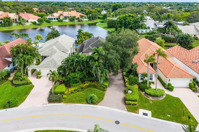 an aerial view of a house with a yard and lake view