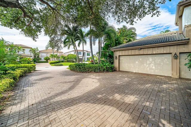 a front view of a house with a yard and a garage