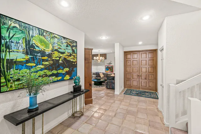 a living room with furniture and paintings on the wall
