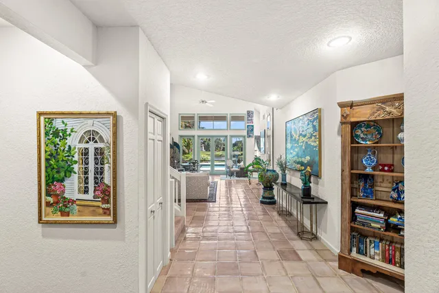 a living room with furniture and large windows