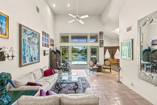 a living room with furniture and a potted plant