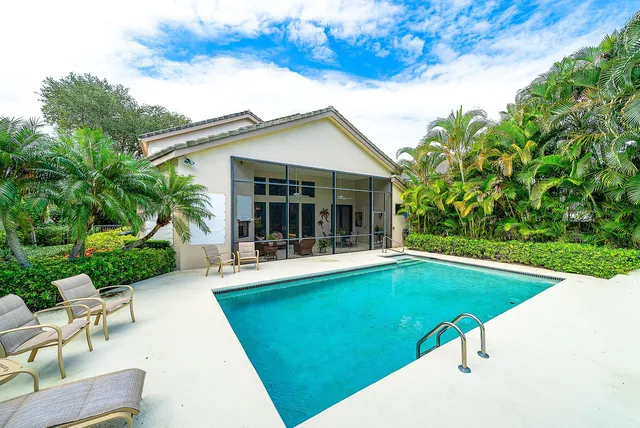 a view of house with swimming pool outdoor seating