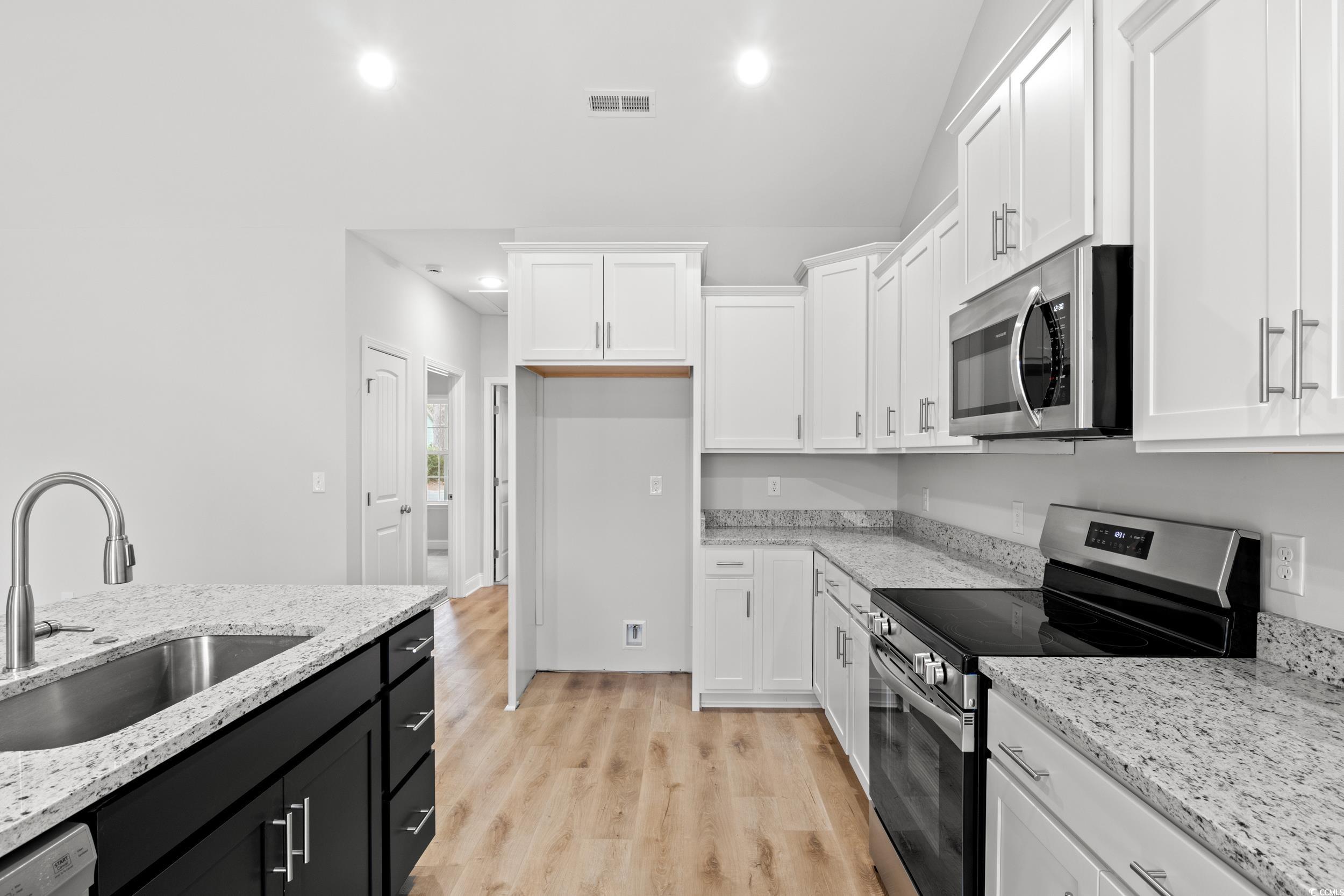 608 Britt Street Georgetown, SC 29440 - Photo 5 of 34 Kitchen featuring visible vents, white cabinets, a
