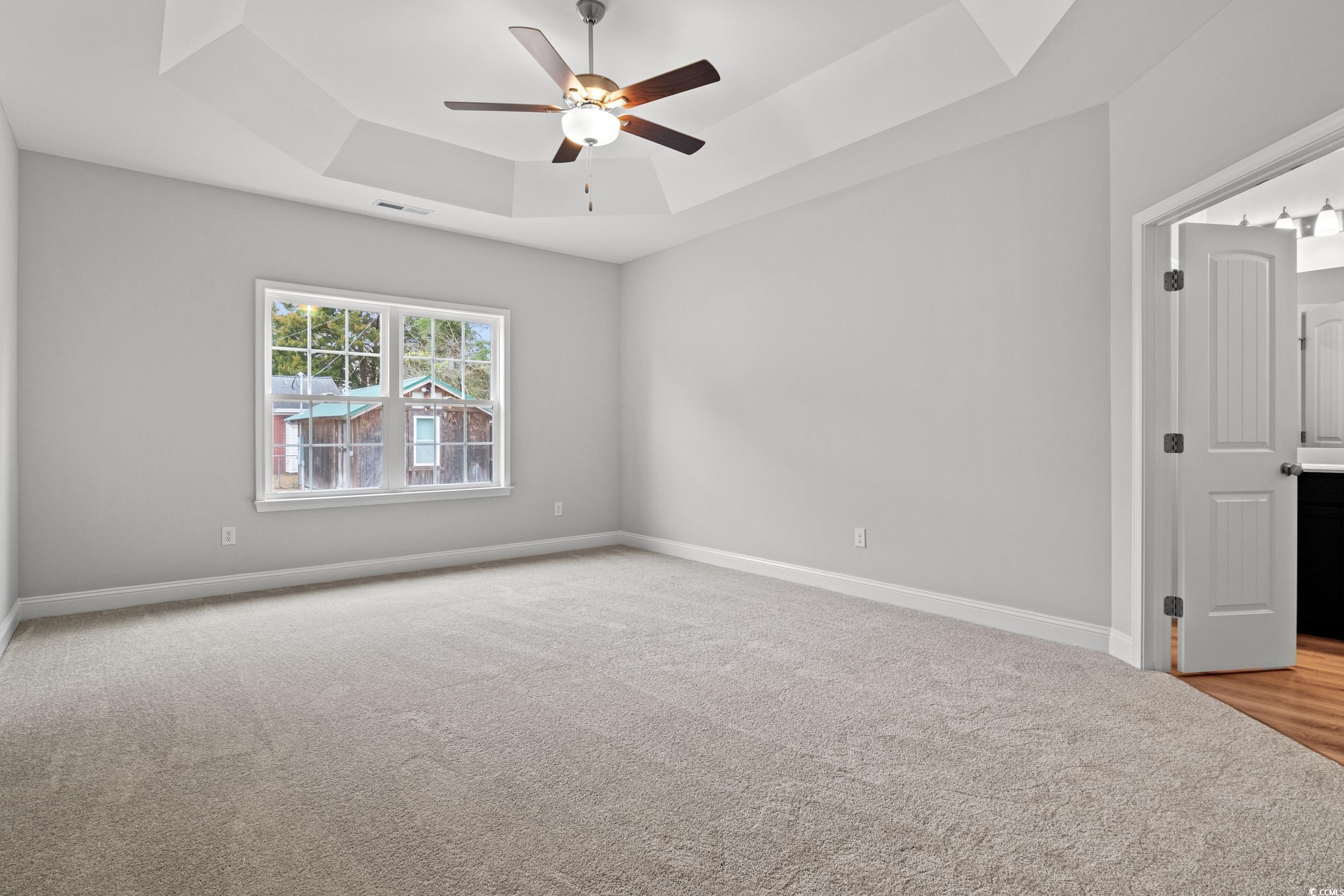 608 Britt Street Georgetown, SC 29440 - Photo 8 of 34 Empty room featuring a tray ceiling, visible vents