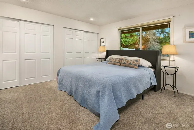 a bedroom with a bed and a lamp