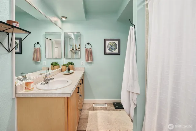 a bathroom with a sink a mirror and a toilet