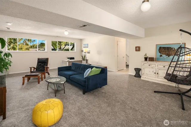 a living room with furniture and a mirror