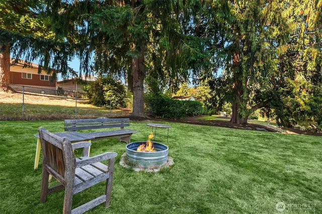 a backyard of a house with table and chairs