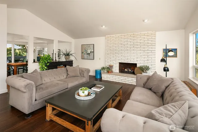 a living room with furniture fireplace and a table