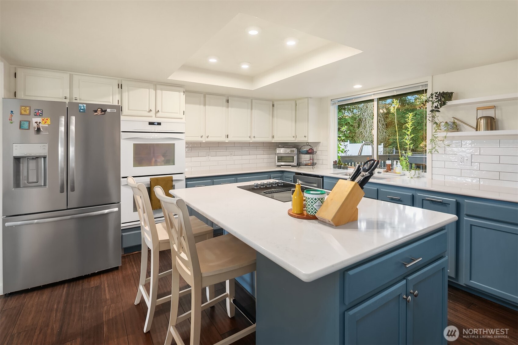 11813 79th Avenue South Seattle, WA 98178 - Photo 6 of 27 a kitchen with stainless steel appliances granite countertop a sink a stove a refrigerator a microwave oven with cabinets and wooden floor