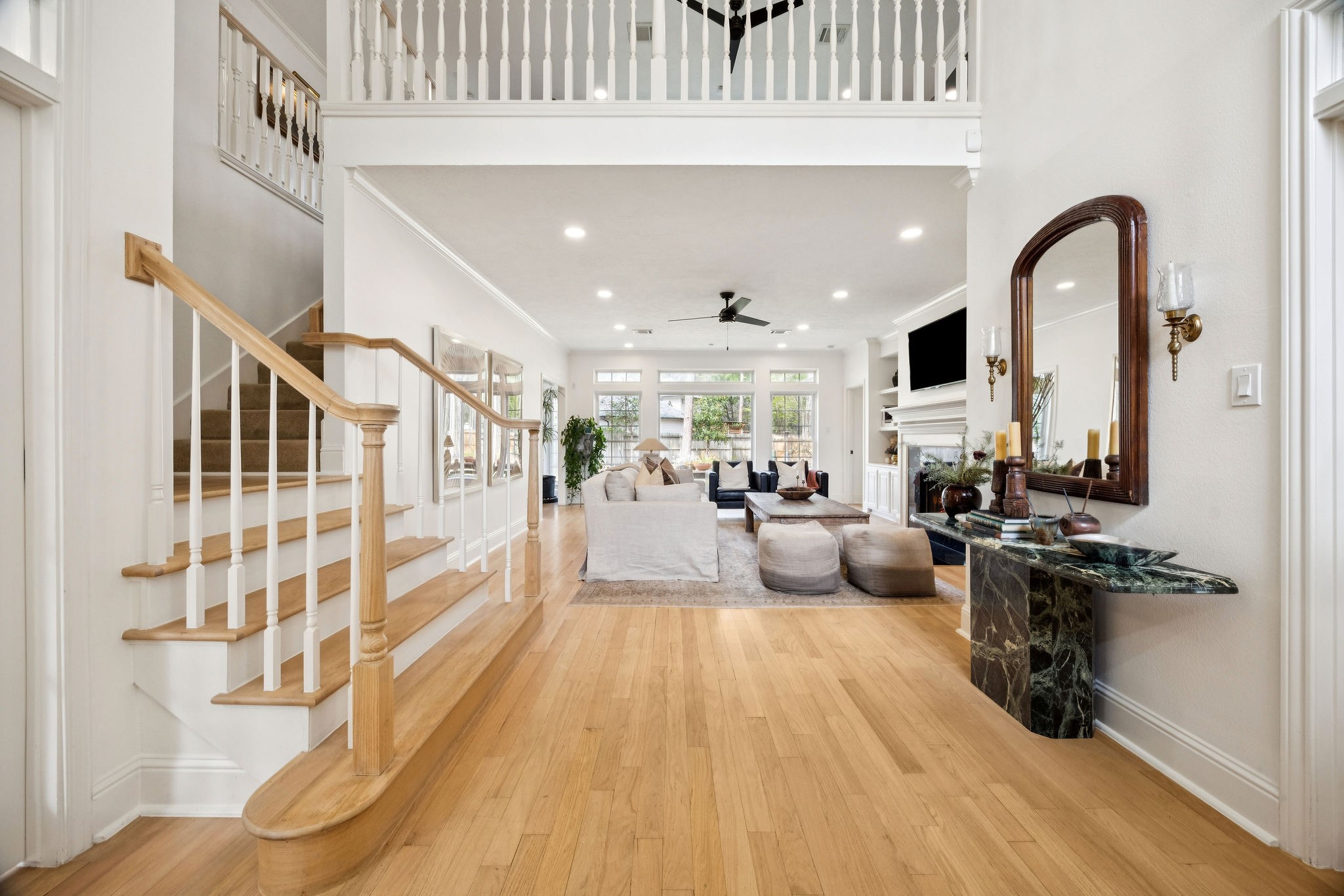 2 North Thundercreek Place Spring, TX 77381 - Photo 5 of 47 Inside, you’re greeted by soaring ceilings, custom-finished oak flooring, abundant natural light, and elevated details throughout.