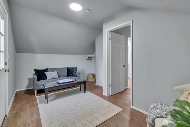 a kitchen with white cabinets and wooden floors