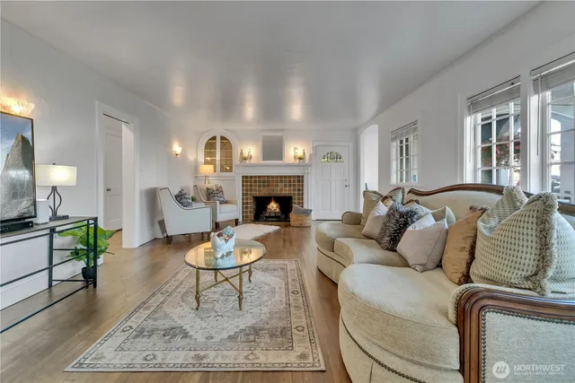 a living room with furniture a rug and a fireplace