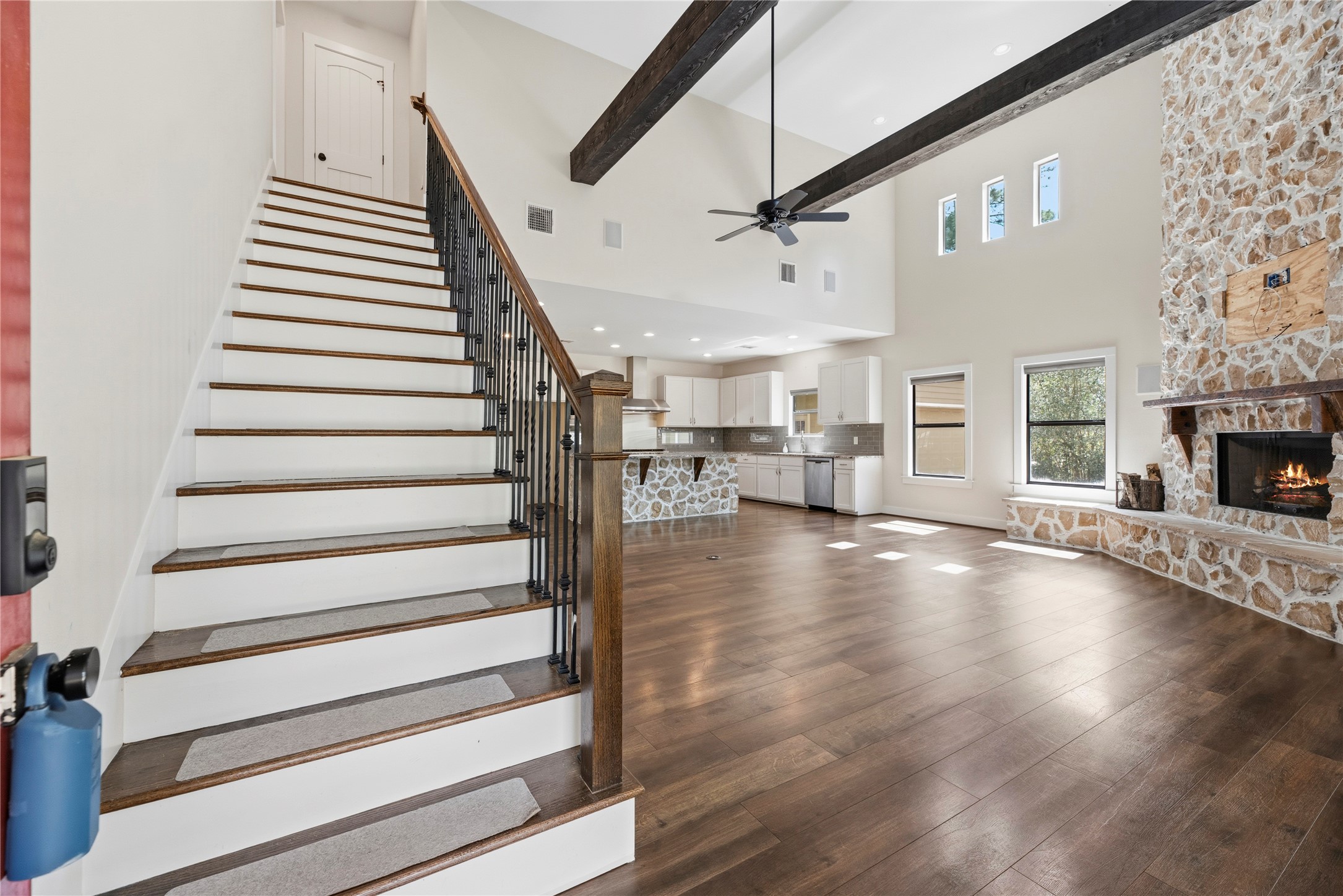 12062 Ike White Road Conroe, TX 77303 - Photo 10 of 37 Beautiful front entry with a wooden staircase, wood flooring and high ceiling.