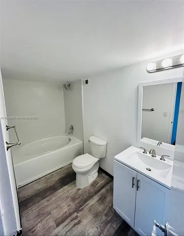 a bathroom with a sink toilet a bathtub and vanity