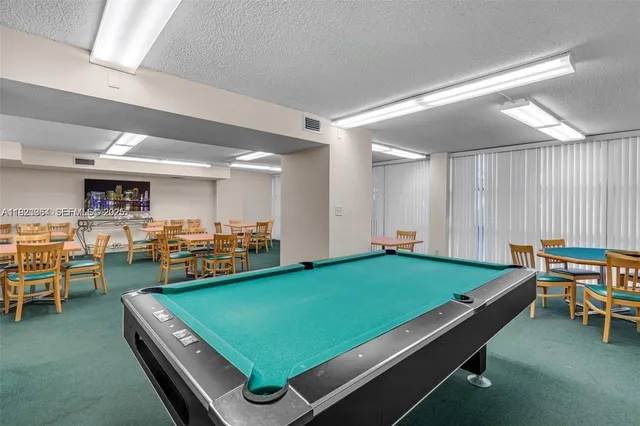 a room with chairs and pool table