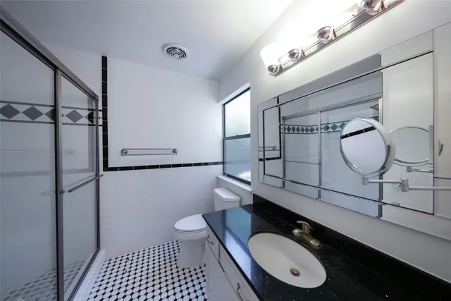 a view of a hallway with wooden floor and cabinet