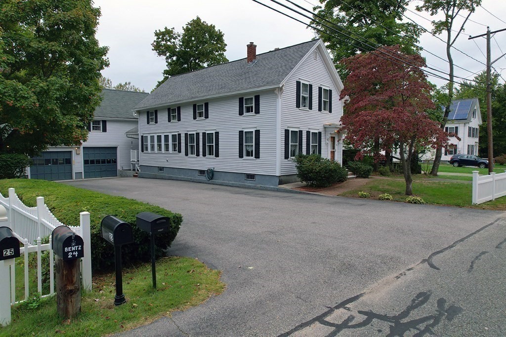 a view of house with a yard and table and chairs