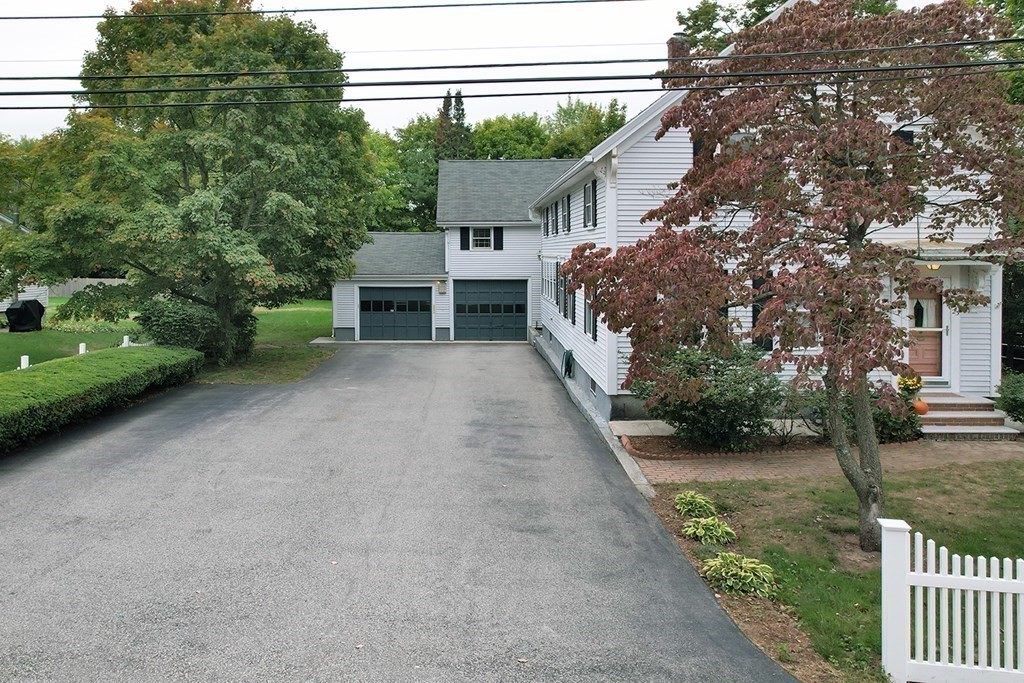 23 Salem Road Billerica, MA 01862 - Photo 2 of 42 a view of a house with a yard and garage