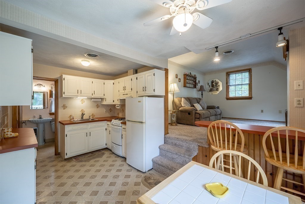 23 Salem Road Billerica, MA 01862 - Photo 28 of 42 a kitchen that has a lot of cabinets a sink and appliances