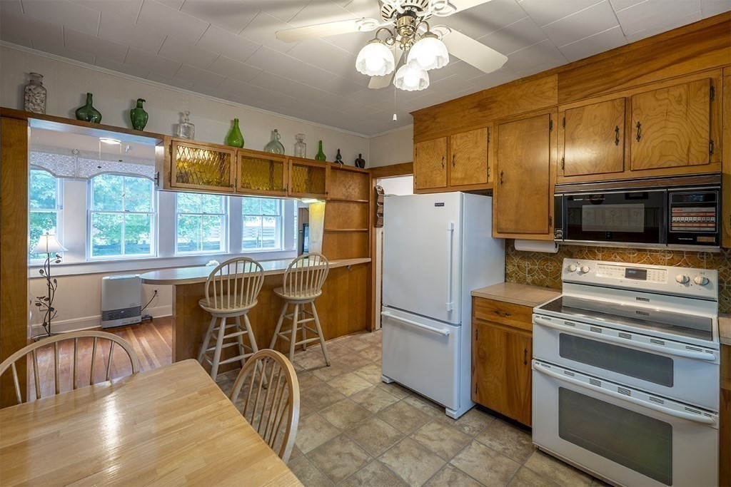 23 Salem Road Billerica, MA 01862 - Photo 6 of 42 a kitchen with stainless steel appliances wooden floor and furniture