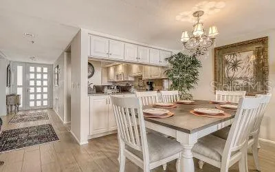 a kitchen with granite countertop a table and chairs in it