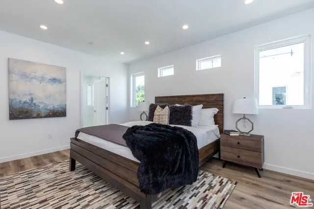 a bedroom with a bed and a painting