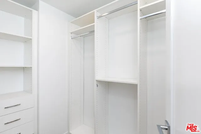 a close view of closet with white walls