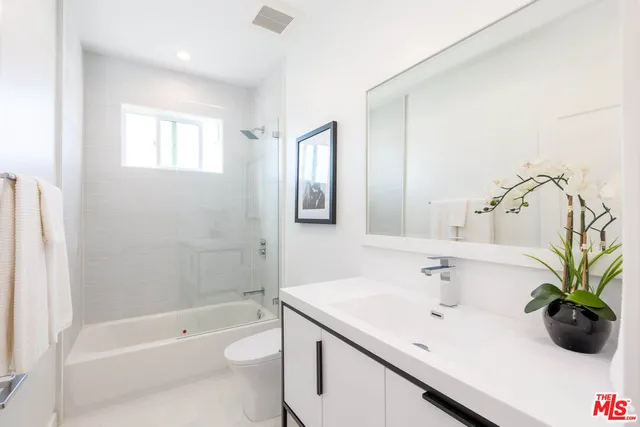 a bathroom with a sink a toilet and bathtub