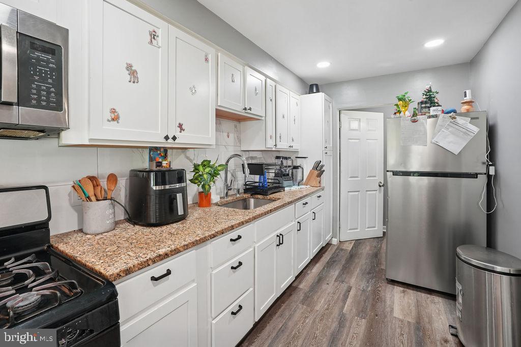 1918 Church Road Baltimore, MD 21222 - Photo 7 of 29 a kitchen with granite countertop a refrigerator stove and sink