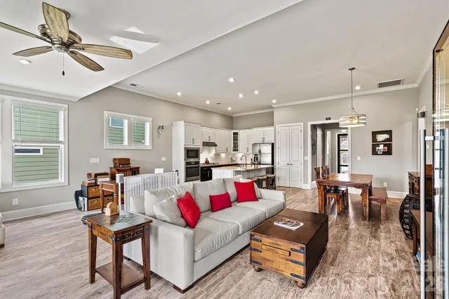 a living room with furniture and kitchen view