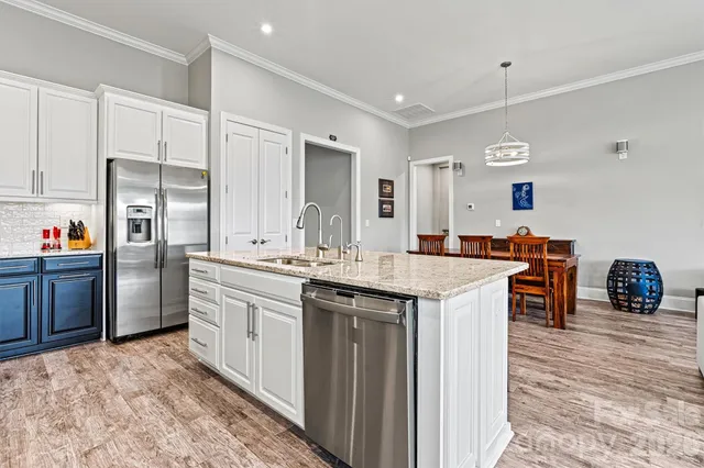 a kitchen with stainless steel appliances granite countertop a sink stove and refrigerator