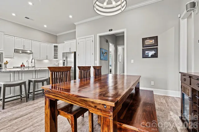 a dining room with furniture and wooden floor