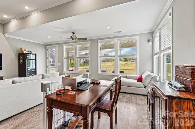 a living room with furniture and floor to ceiling windows