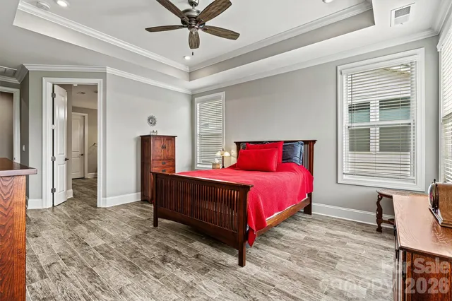 a bedroom with a bed dresser and a window