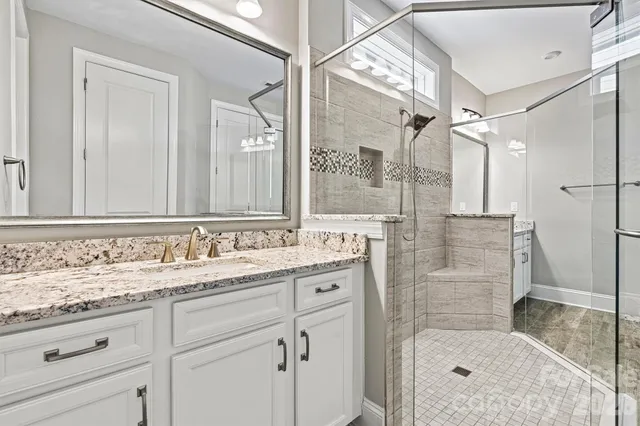 a bathroom with a granite countertop sink mirror and double