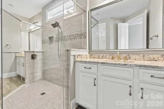 a bathroom with a shower sink and mirror