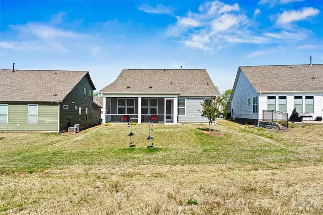 a view of a house with a backyard