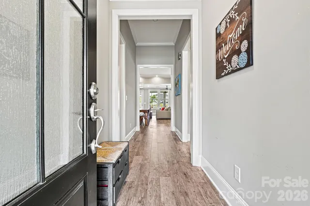 a view of a hallway view with wooden floor and staircase