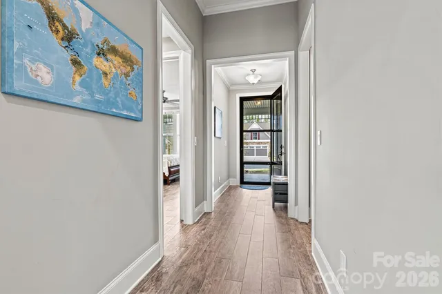 a view of a hallway with wooden floor and closet