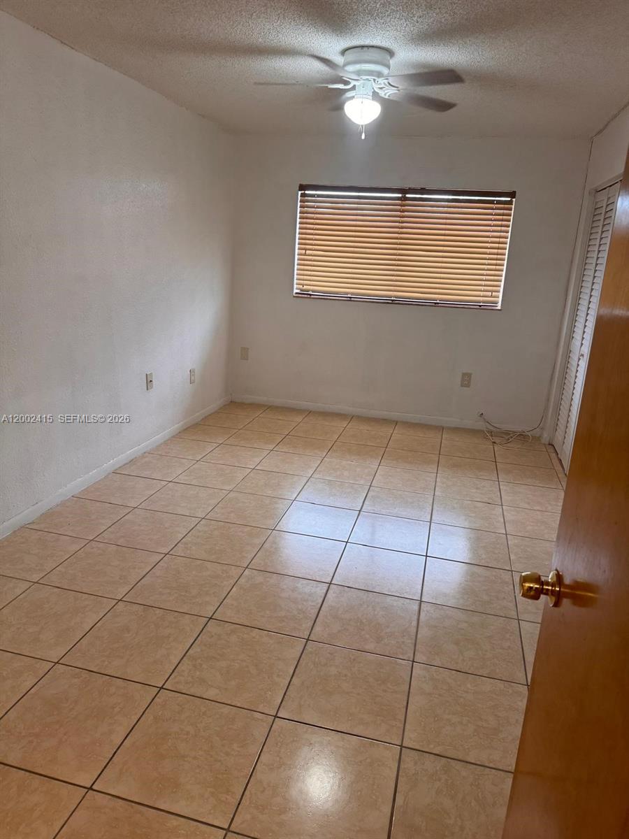 180 Royal Palm Road, Unit 216 Hialeah Gardens, FL 33016 - Photo 16 of 20 a view of a livingroom with a chandelier fan and windows