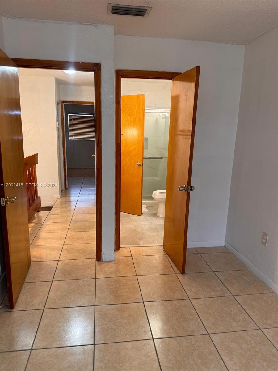 180 Royal Palm Road, Unit 216 Hialeah Gardens, FL 33016 - Photo 18 of 20 a bathroom with a sink a toilet and a shower