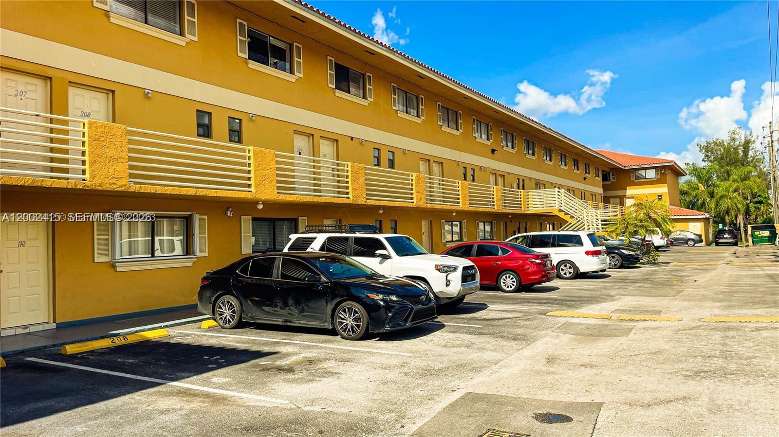 180 Royal Palm Road, Unit 216 Hialeah Gardens, FL 33016 - Photo 2 of 20 a car parked in front of a building