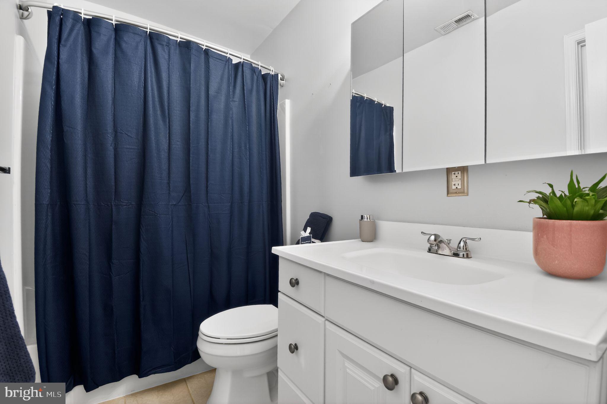 1227 Meigs Place Northeast, Unit C Washington, DC 20002 - Photo 16 of 17 a bathroom with a sink a toilet and vanity