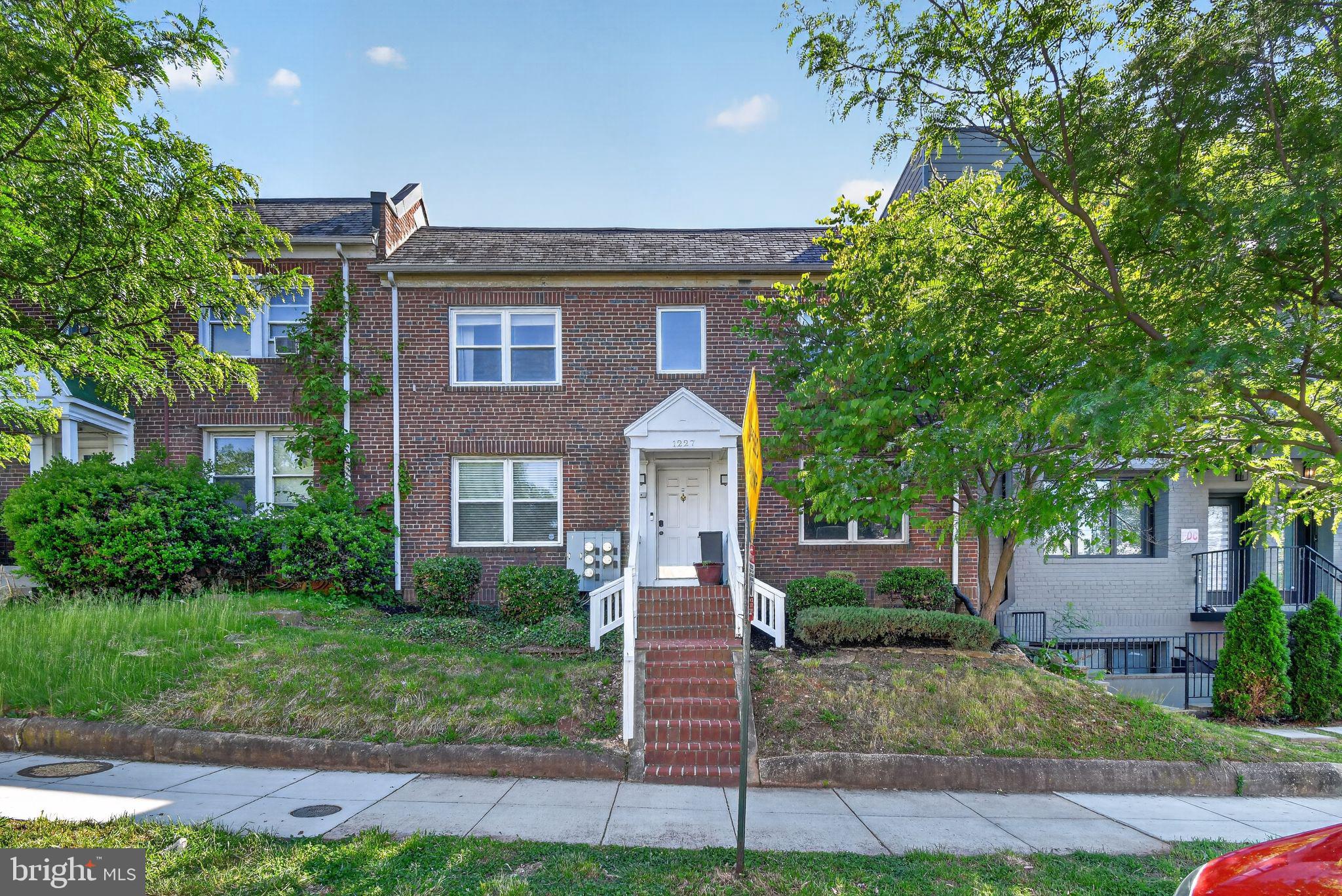 1227 Meigs Place Northeast, Unit C Washington, DC 20002 - Photo 2 of 17 a front view of a house with a garden