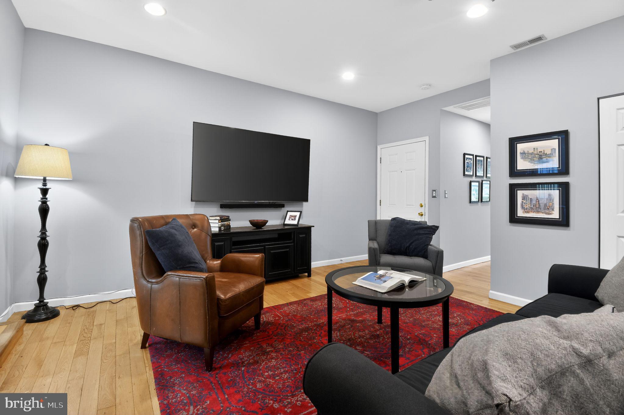 1227 Meigs Place Northeast, Unit C Washington, DC 20002 - Photo 6 of 17 a living room with furniture and a flat screen tv