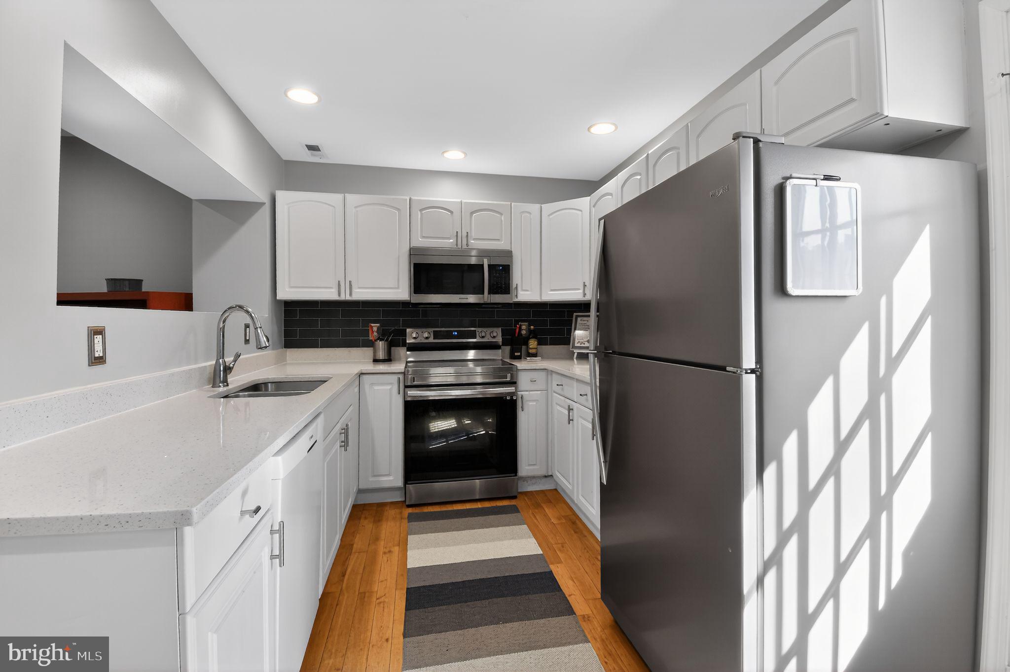 1227 Meigs Place Northeast, Unit C Washington, DC 20002 - Photo 7 of 17 a kitchen with stainless steel appliances a refrigerator sink and microwave
