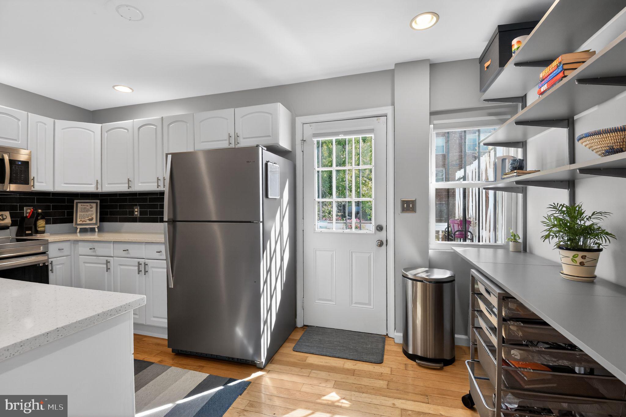 1227 Meigs Place Northeast, Unit C Washington, DC 20002 - Photo 8 of 17 a kitchen with stainless steel appliances a refrigerator a sink a stove and cabinets